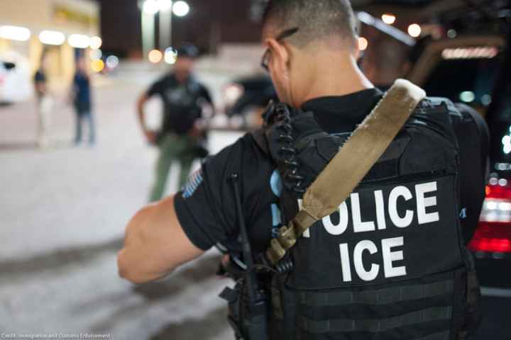 The back of a police vest reads "Police ICE"