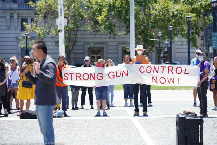 Protesters hold a banner that says "Strong gun control now" during an anti-gun violence rally in San Francisco rally.