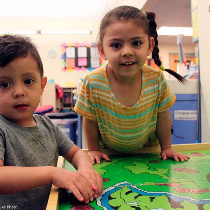 A young boy and girl play with their toy cars to wrap up the day at a day care Albuquerque, New Mexico