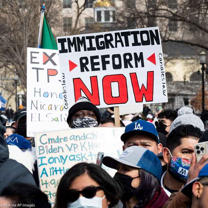 A group of immigration reform demonstrators with a sign that says "Immigration Reform Now."