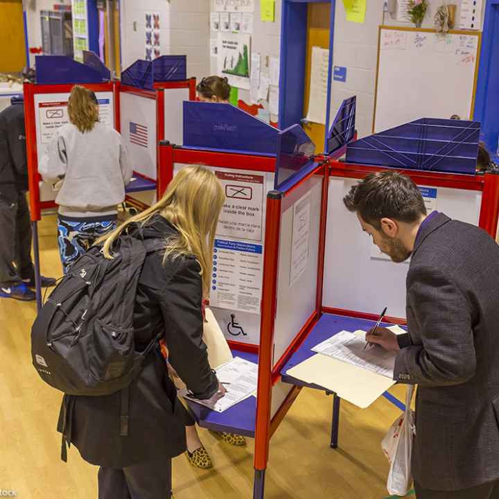 Voters fill out paper ballots on election day.