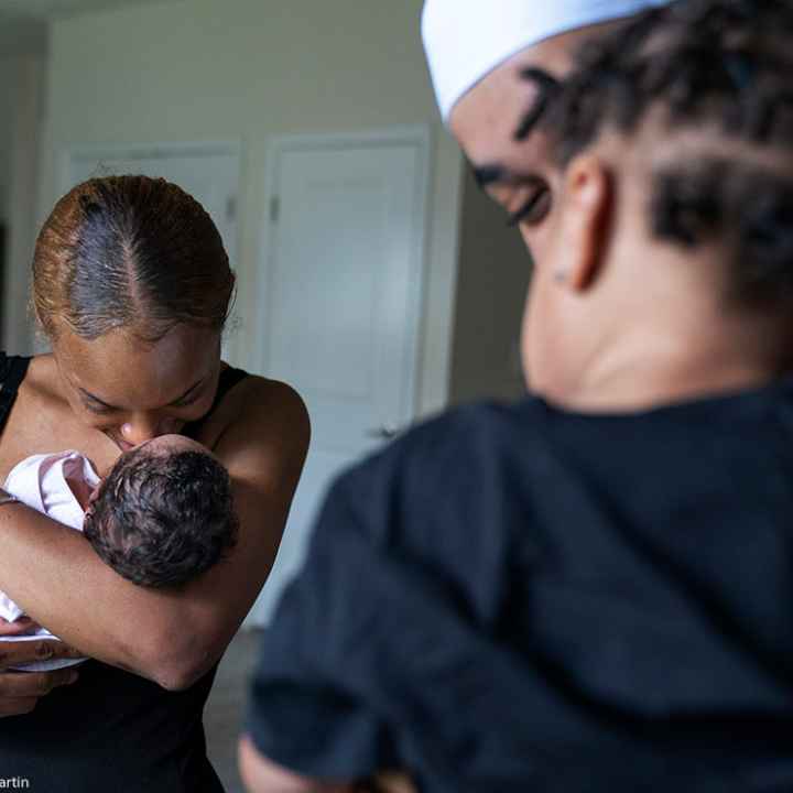 A couple holding their two children.