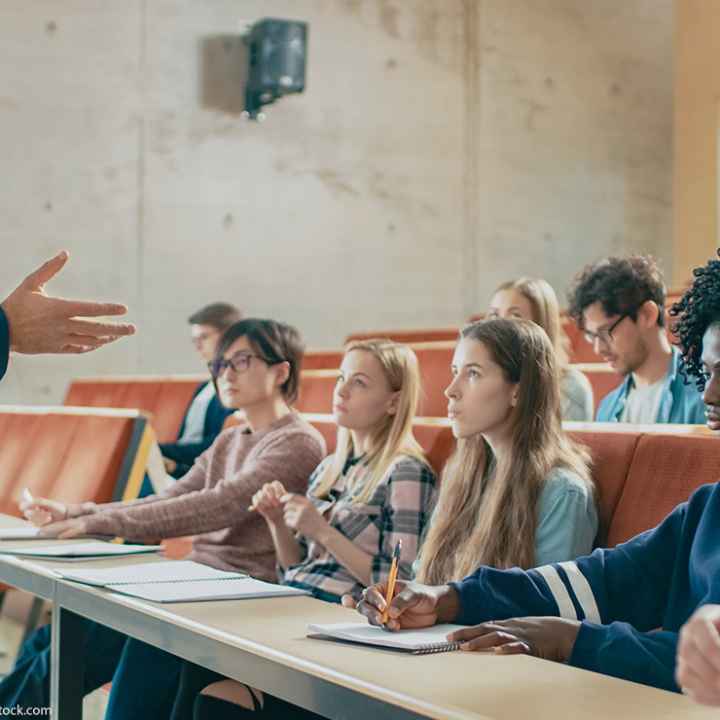 A professor holding a lecture to a group of students.