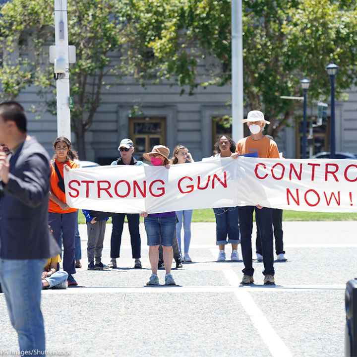 Protesters hold a banner that says "Strong gun control now" during an anti-gun violence rally in San Francisco rally.